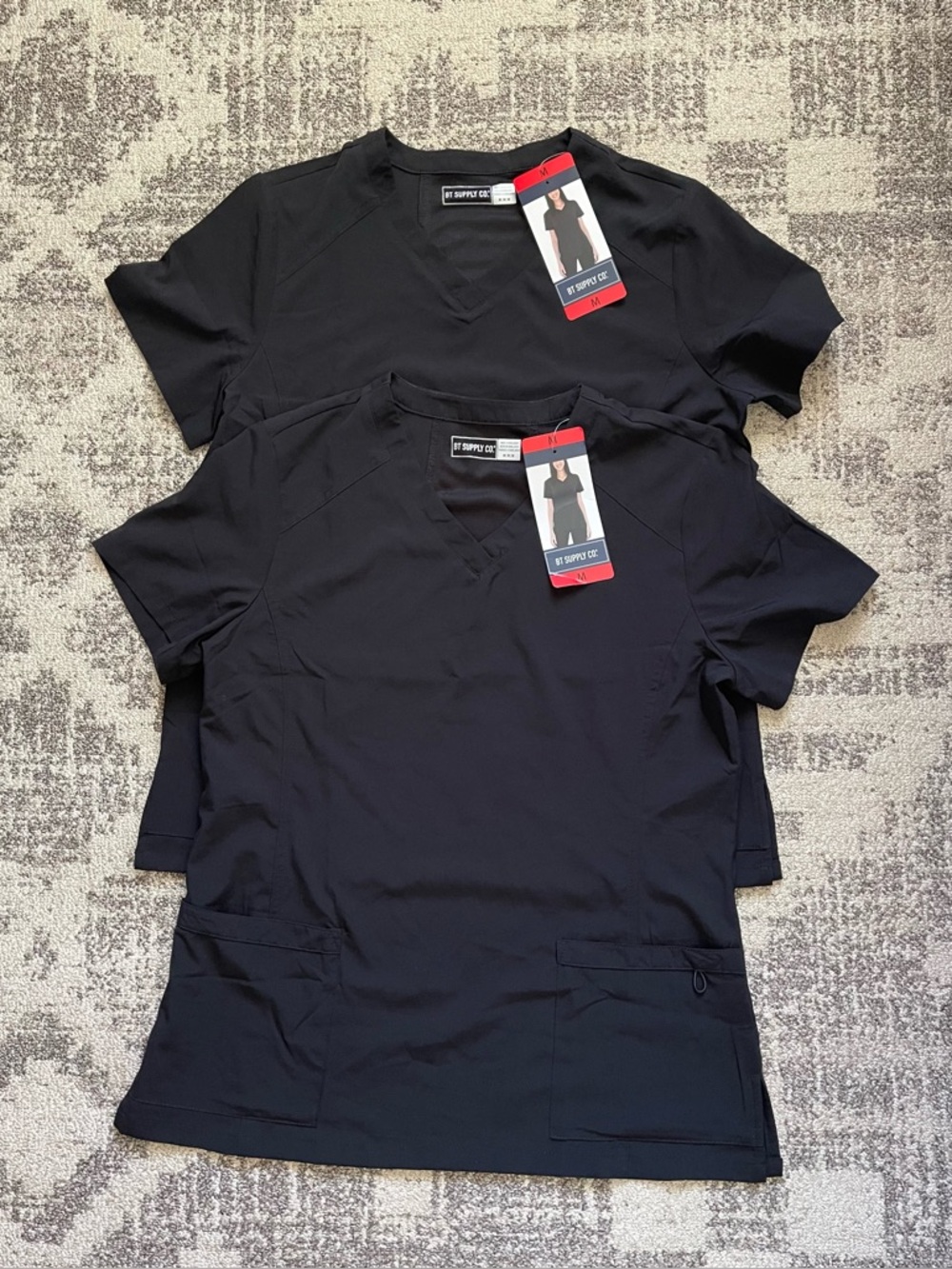 2 New Black BT Supply Co. women's scrub tops, v-neck design, multiple pockets.
